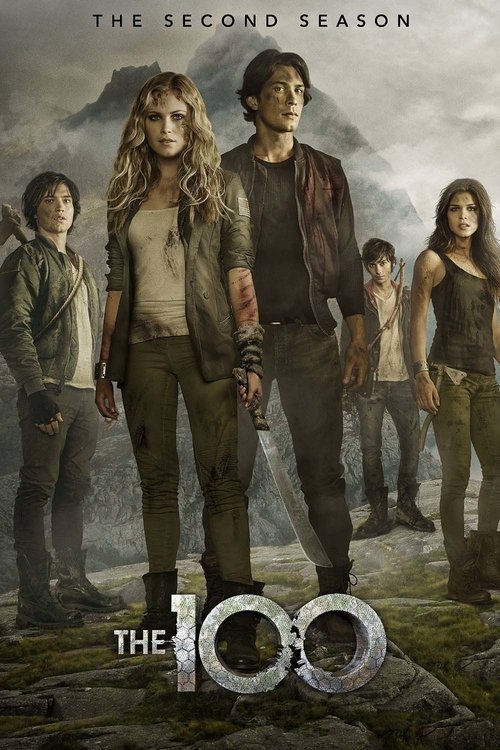 Five young adults in rugged, worn clothing stand together on rocky terrain with mountains and a cloudy sky behind them. Text above reads The Second Season and at the bottom, The 100—now streaming on IPTV Latino.