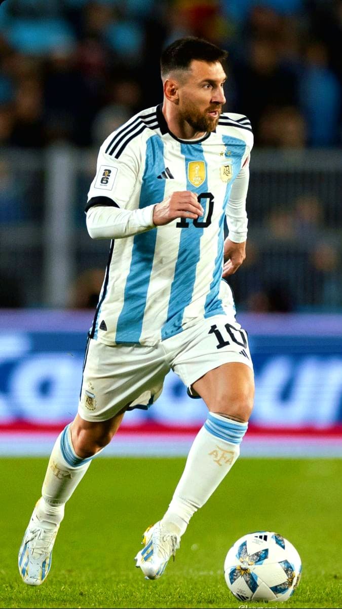 A soccer player in Argentina’s national team uniform runs on the field, dribbling a ball. Tune into IPT﻿V Latino to catch all the action—he wears a white and light blue jersey with number 10 and white shorts, focused during a thrilling match.
